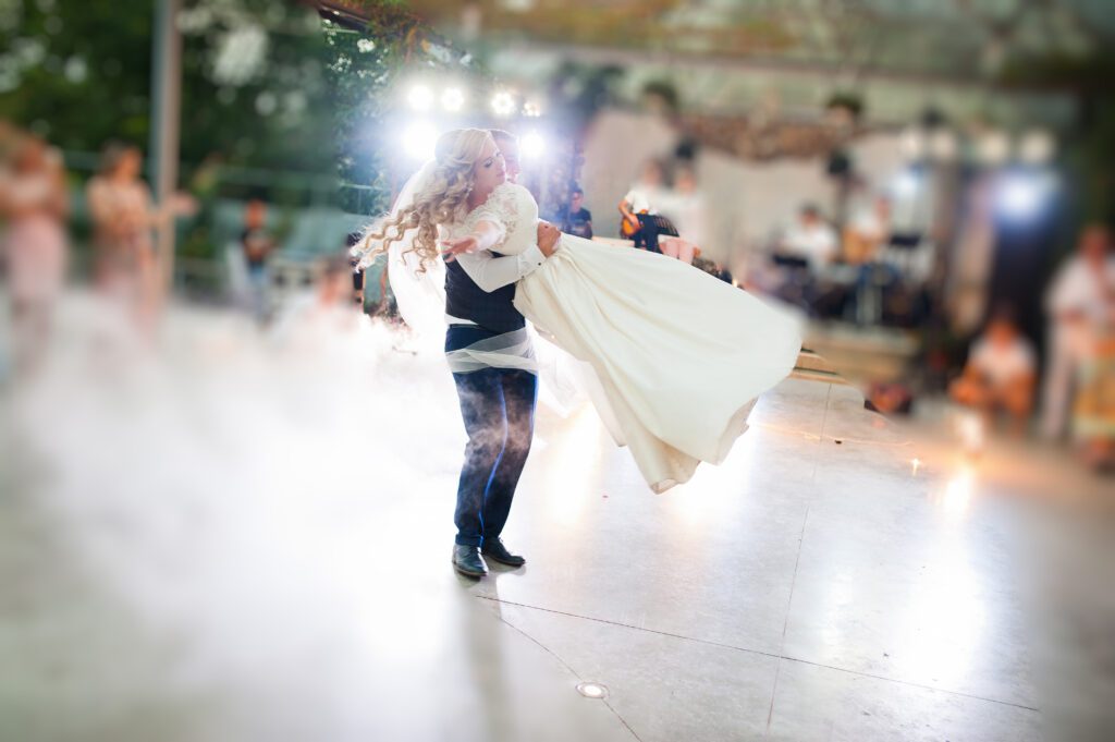 Amazing first wedding dance of newlyweds at heavy smoke and fireworks.